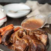 Pouring gravy over beef short ribs
