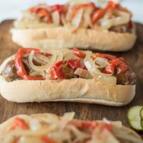 Slow cooker  beer brats with peppers and onions are the perfect, easy cookout meal for a crowd. Brats are slow cooked in German beer along with peppers and onions, pile onto a bun and you’re set.