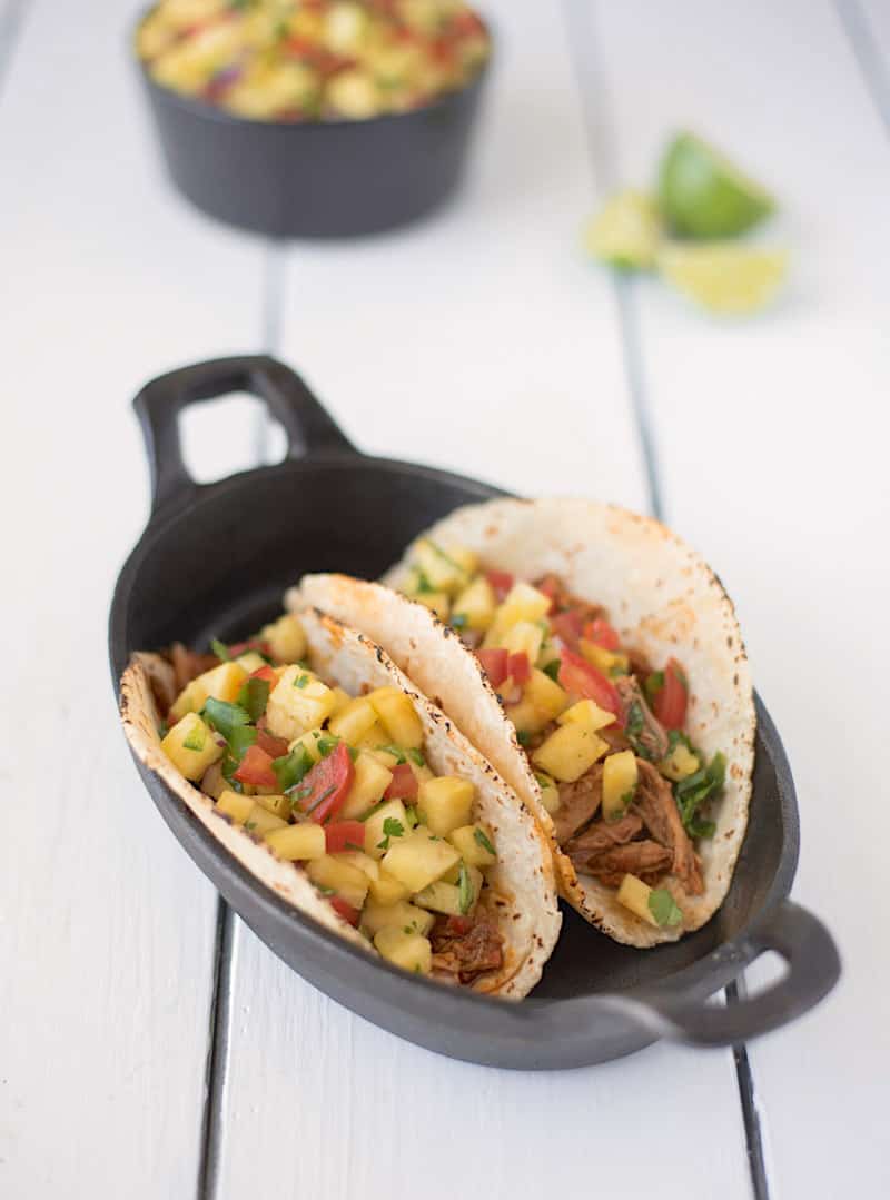 Slow cooker pineapple pepper carnitas tacos in a cast iron skillet