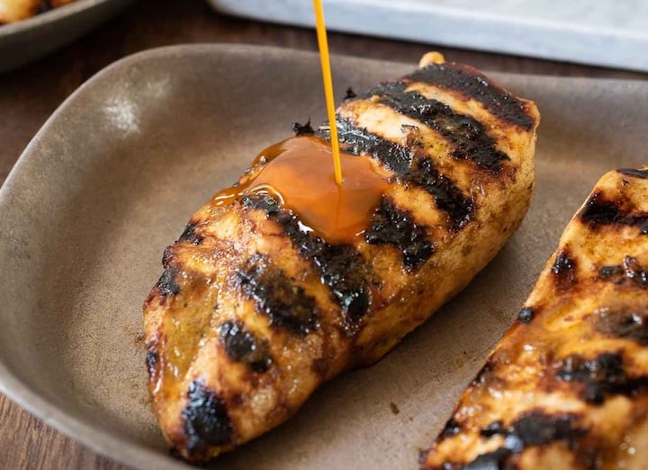 2 grilled chicken breasts with sauce