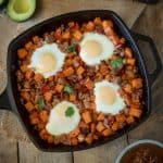 An overhead image of the breakfast skillet with fresh avocado and salsa.