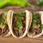 Slow cooked shredded beef and hatch chile soft tacos