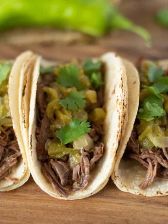 Slow cooked shredded beef and hatch chile soft tacos
