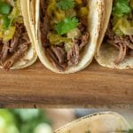 Shredded beef inside corn tortillas with Chile sauce and cilantro