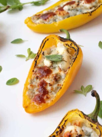 7 Sweet mini peppers on a serving board garnished with greens