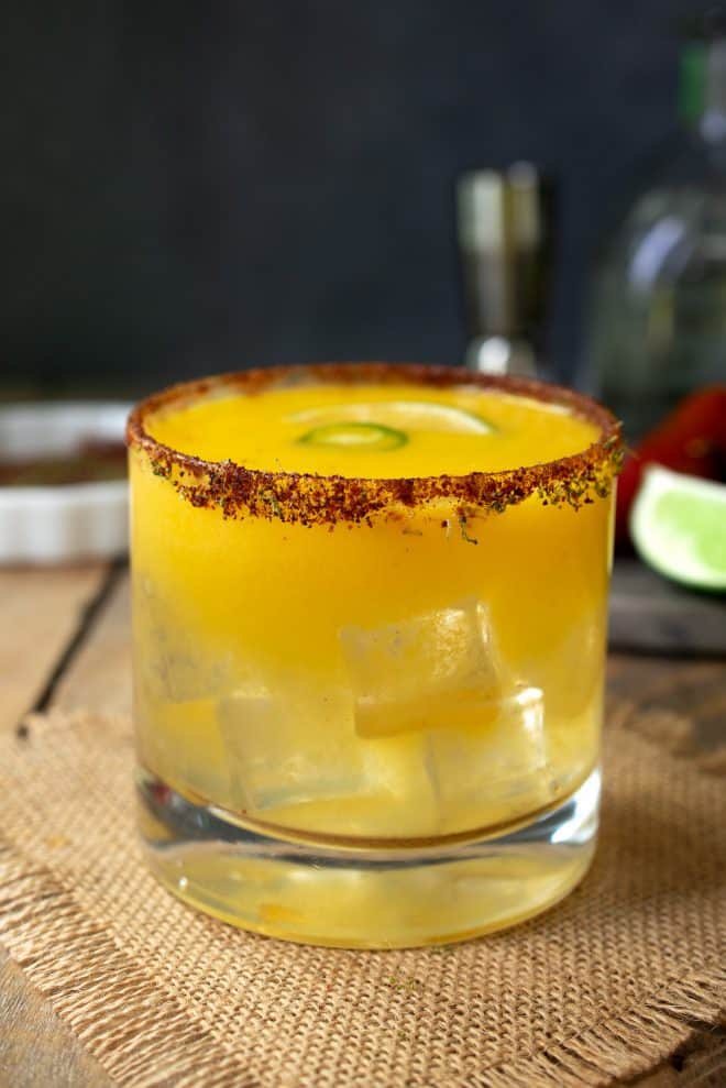 A side view showing the glass filled with ice and the chili lime salt rim