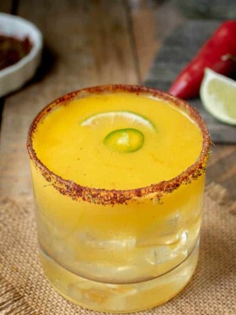 Spicy Jalapeño Mango Margarita with chili peppers and lime