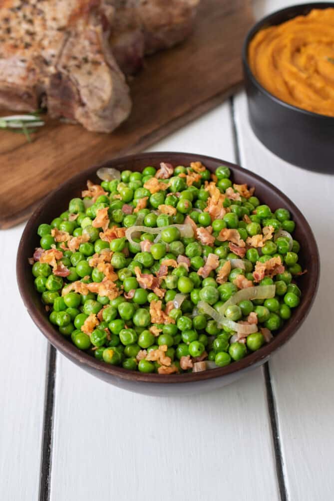Peas and pancetta in a wood bowl
