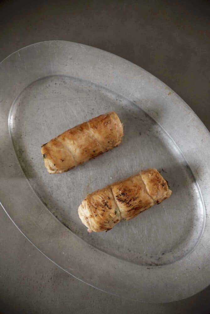 2 chicken roulades/rolls on a pewter plate