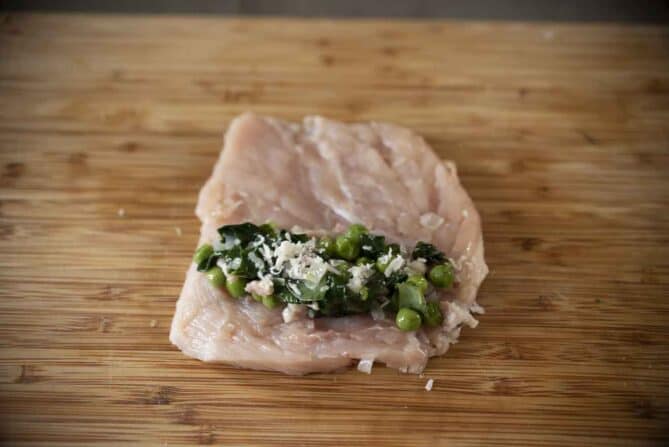 Spinach, peas and pancetta on a chicken breast