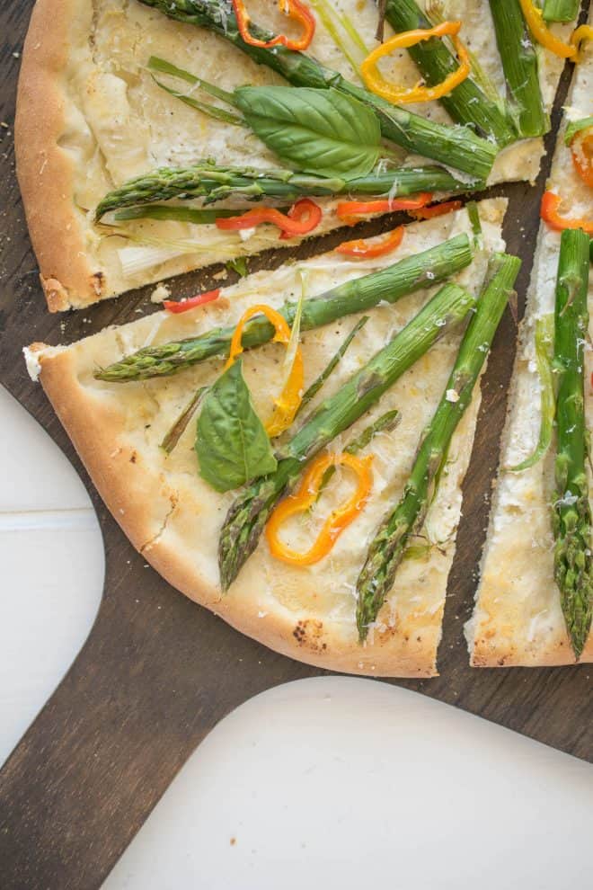 A slice of spring vegetable pizza closeup