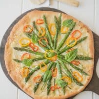 The pizza viewed from overhead showing the pretty vegetable topping