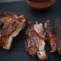 Cut baby back ribs with a bowl of Guinness sauce