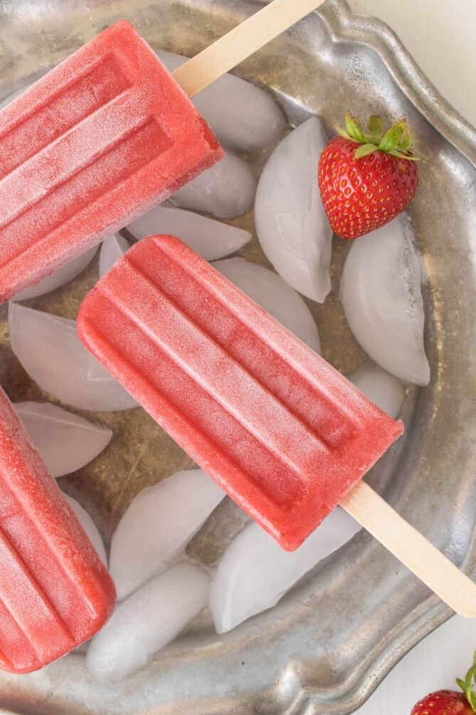 A closeup of a strawberry popsicle that is icy