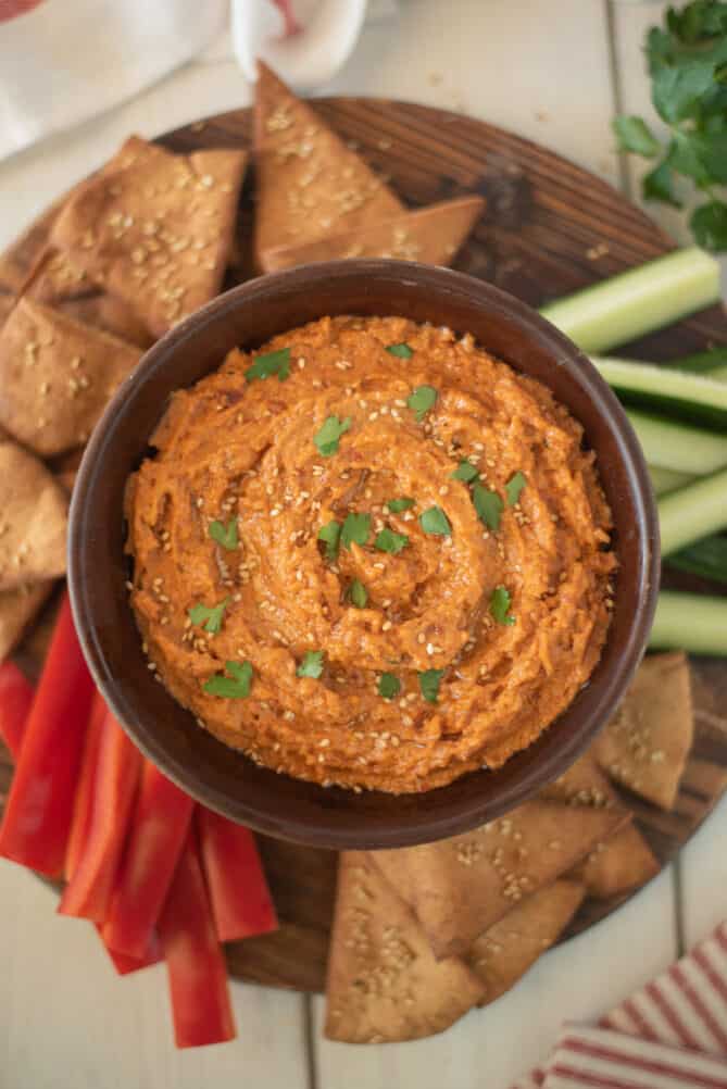 Sun-dried tomato hummus from overhead with pita chips and vegetables
