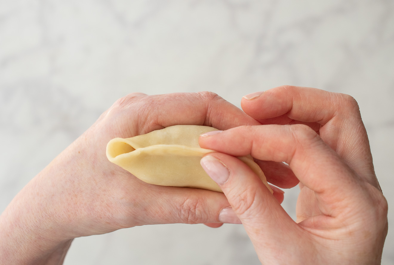 Pinching dough to seal the edges