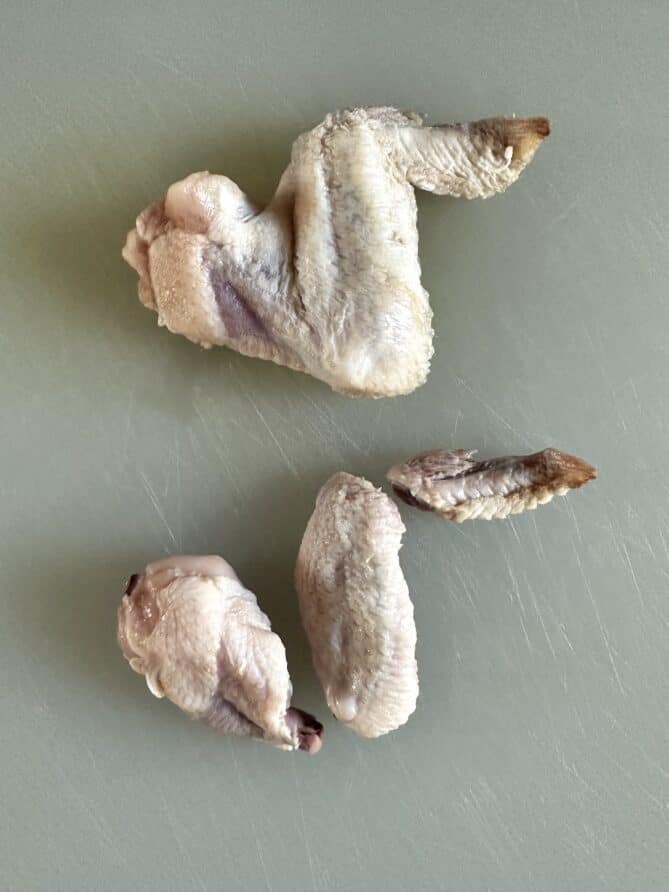 2 chicken wings, one whole and one cut into pieces