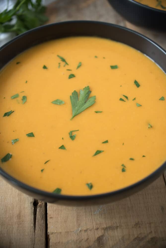 A closeup of butternut squash soup showing how smooth it is