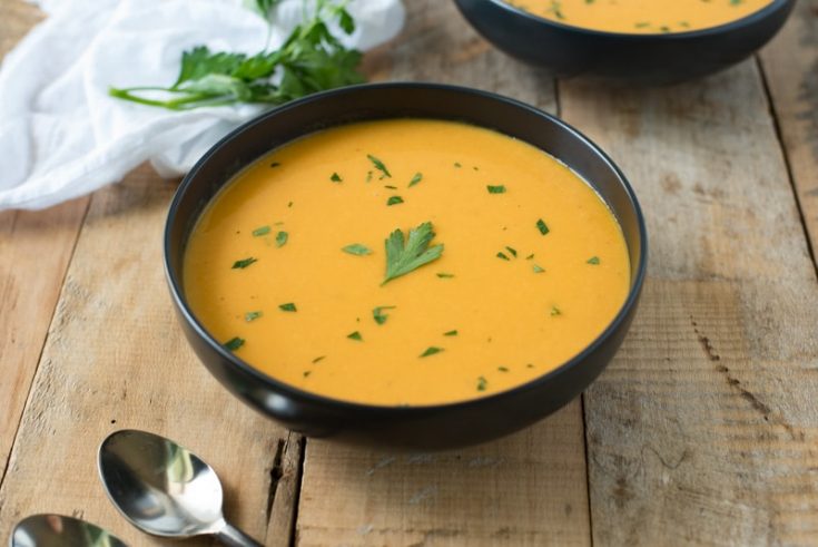 A freshly served bowl of Thai butternut squash soup