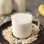 Oat milk on a wooden plate