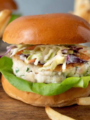 A flaky white fish burger viewed from the side