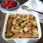 A square baking dish filled with bread and butter pudding