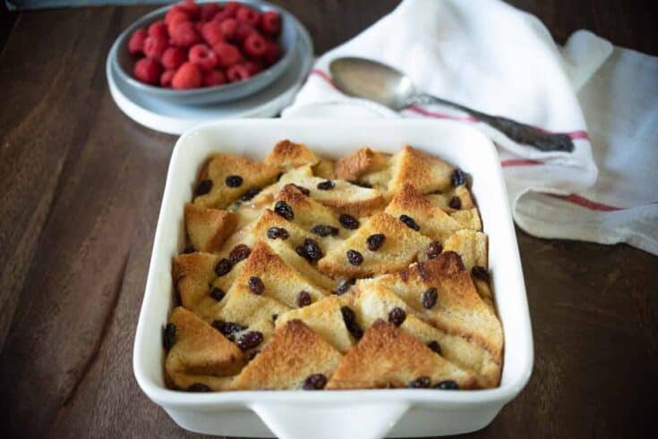 A square baking dish filled with bread and butter pudding