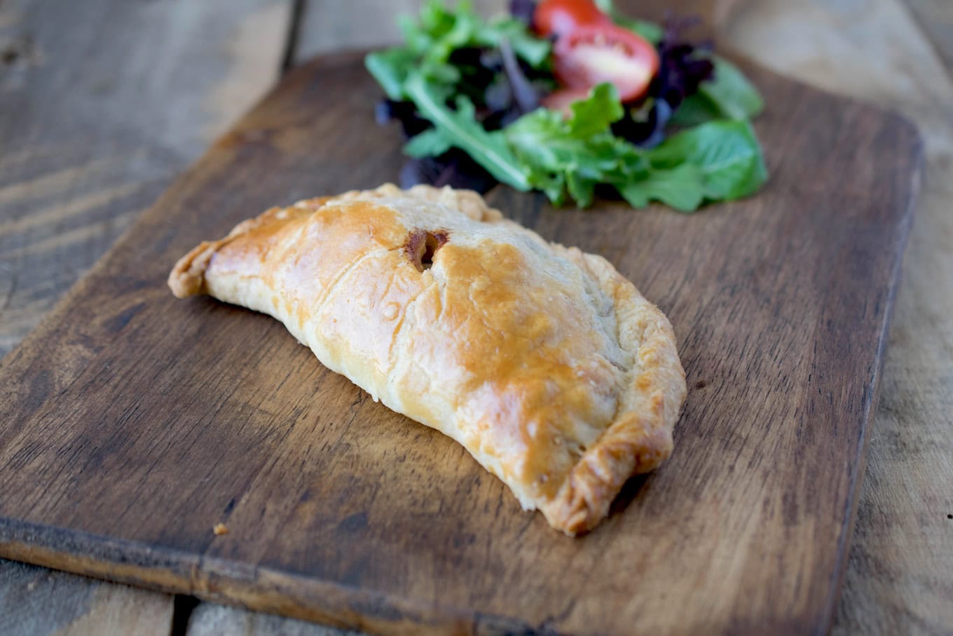 A Cornish pasty on a board