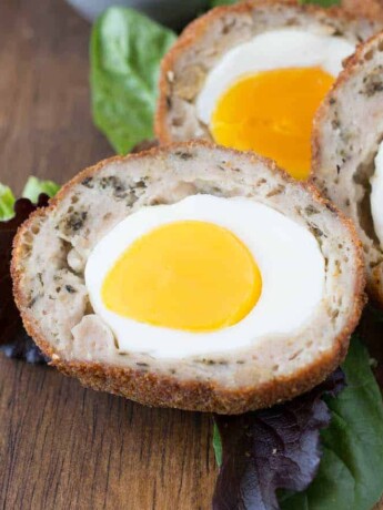 A closeup of the inside of a Scotch egg showing the bright yolk