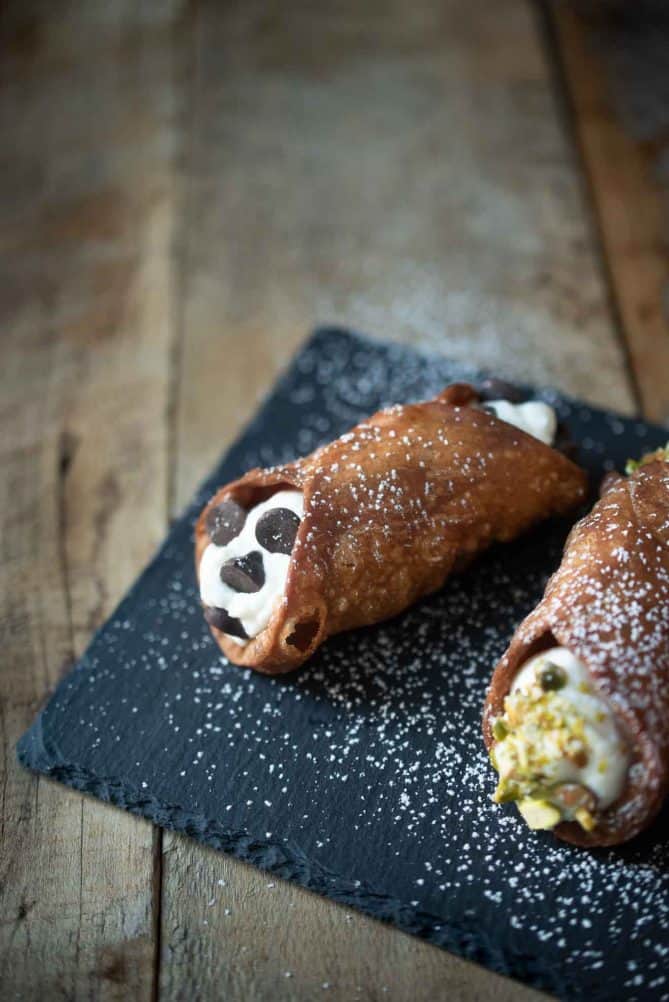 A closeup of a cannoli studded with chocolate chips