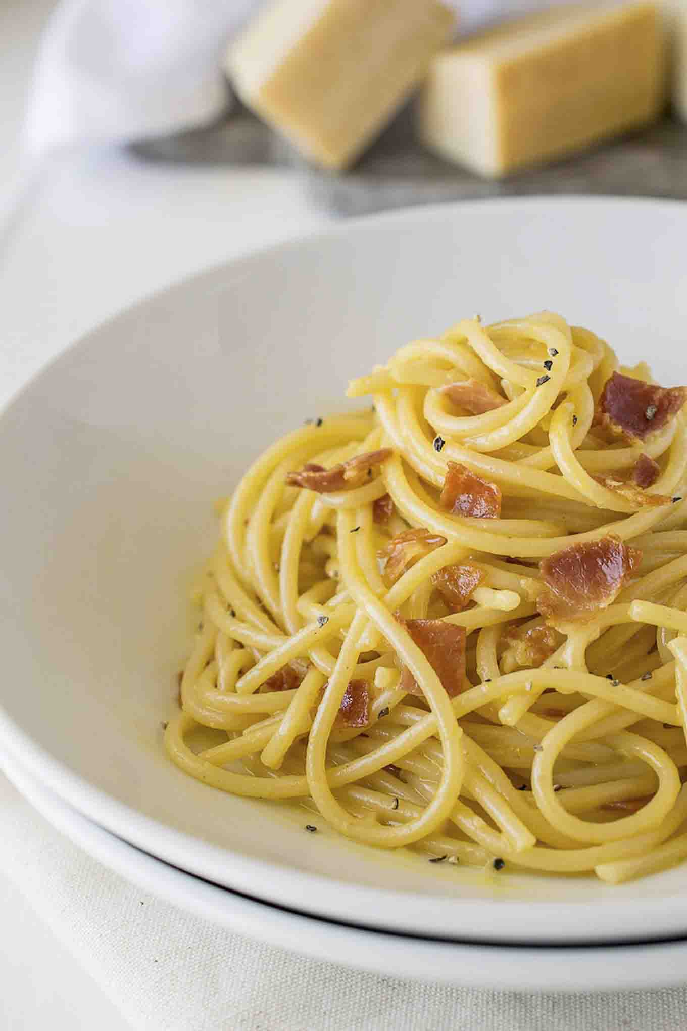 A close up of mounded spaghetti carbonara