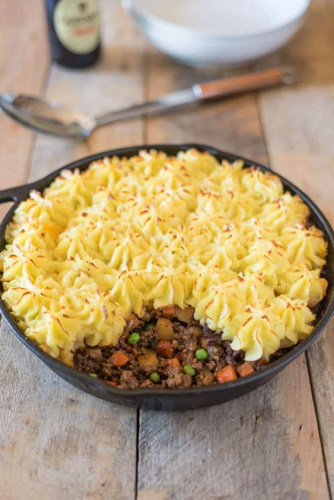 Shepherd's pie with some of the mash topping removed to reveal the beef and vegetable filling