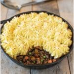Shepherds pie in a skillet and a spoonful