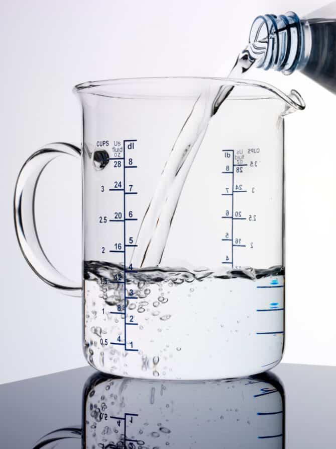 Pouring water into a measuring jug
