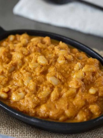 Baked beans in a tomato sauce served in an oval dish