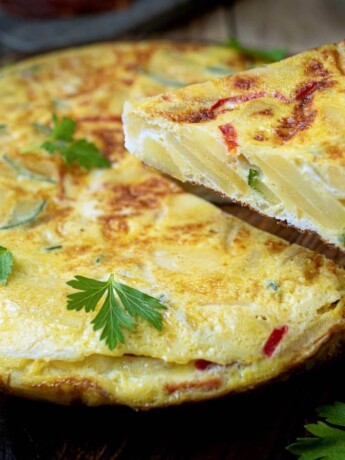 Serving a slice of potato and vegetable Spanish omelette