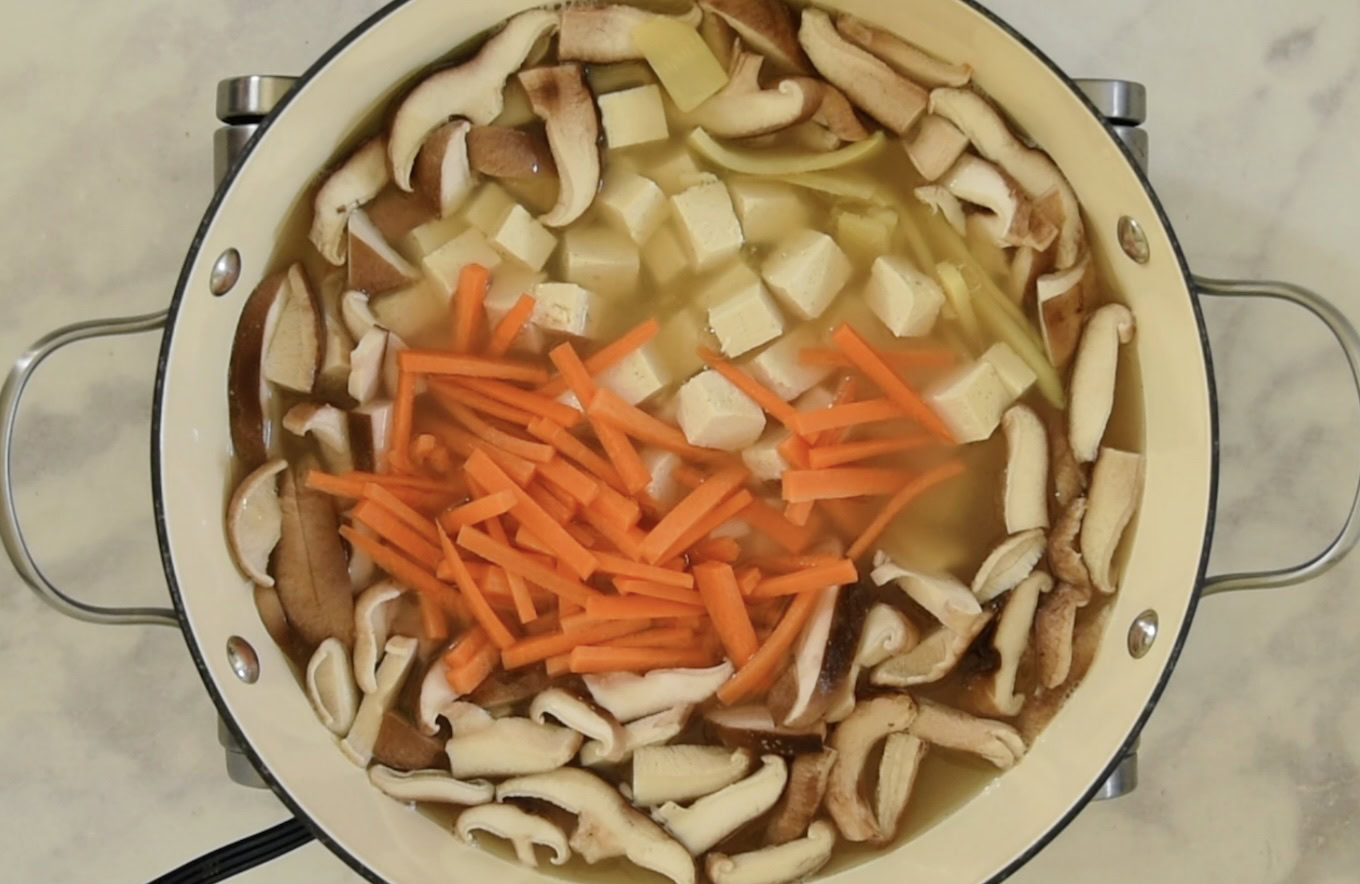 Mushrooms, tofu and carrots in hot and sour soup