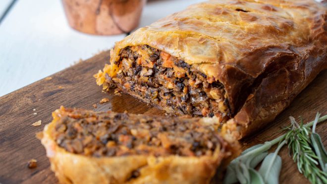 Mushroom Wellington sliced showing the mushroom and vegetable meaty center
