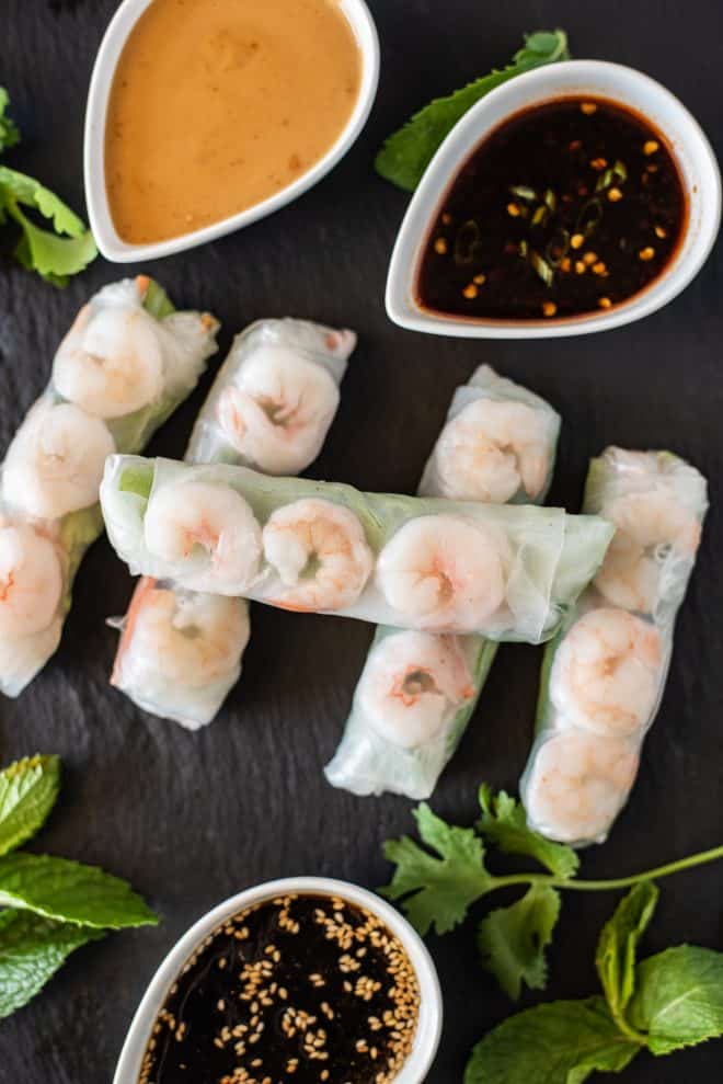 Shrimp summer rolls where you can see the shrimp through the wrapper with dipping sauces