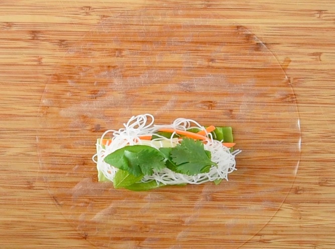 Fresh mint, basil and cilantro is added on top of the rice noodles