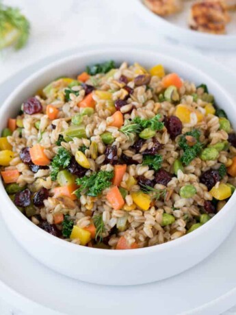 Farro grains mixed with colorful vegetables in a bowl