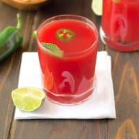 2 glasses watermelon jalapeño agua fresca garnished with jalapeño slices and fresh mint and a wedge of lime