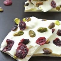 Smooth white chocolate, hardened topped with pistachios and dried cranberries