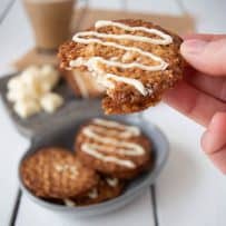 A bite take out of a white chocolate Florentine cookie