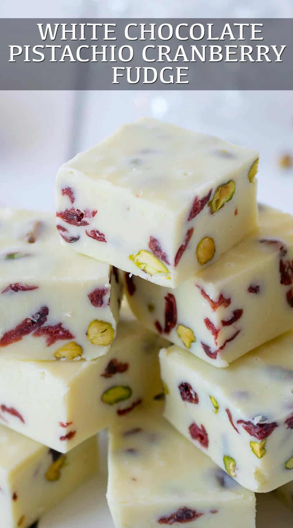 Gorgeous red cranberries against the white chocolate fudge and green pistachios