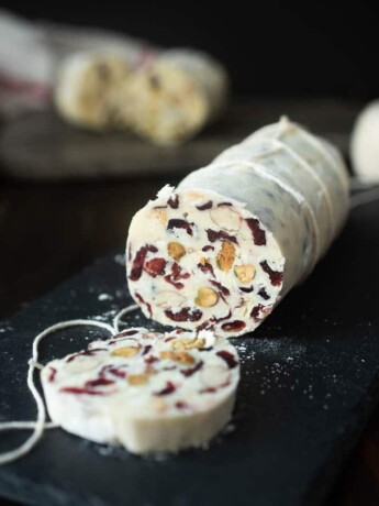 A white chocolate log studded inside with nuts, and dried cranberries