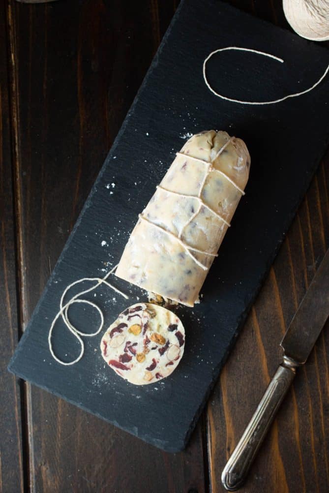 White chocolate salami viewed from overhead showing the string wrapped around and a slice