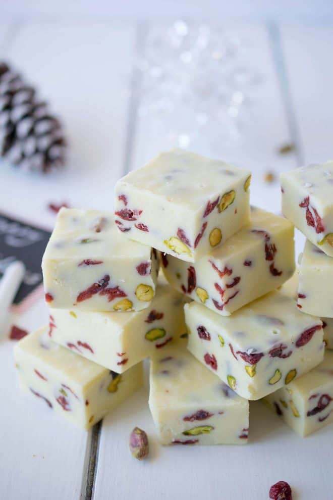 White Chocolate Pistachio Cranberry Fudge squares stacked on top on each other
