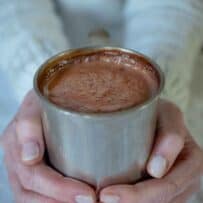 2 hands holding a mug of Baileys Belgian hot chocolate