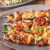 A grey serving platter with Grilled Thai Chicken Kabob Skewers